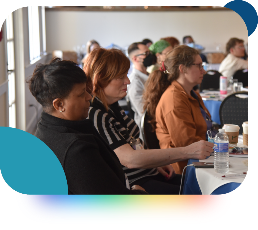 People during an event listening to someone speak, paying close attention. 
